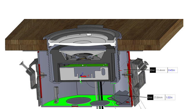 Section view of housing, collar, lighting module, optic cup, and adapter plate in wall.